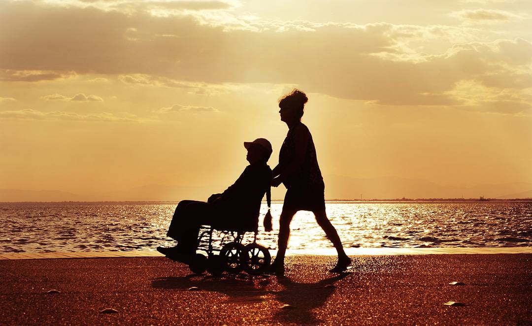 wheelchair walk on beach at sunset